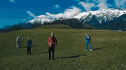 a group of people standing in a field with the words glück gehabt