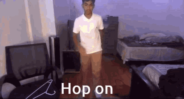 a man in a white shirt is standing in a room with a hanger on the floor .