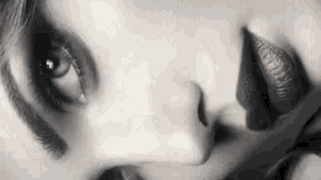 a close up of a woman 's face with her tongue out .