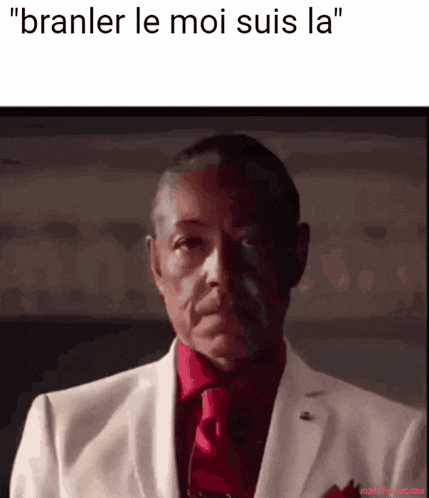 a man in a white suit and red tie with the caption " branler le moi suis la " on the bottom