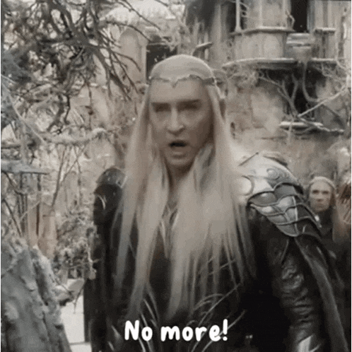 a man with long blonde hair and a crown on his head is standing in front of a group of people .