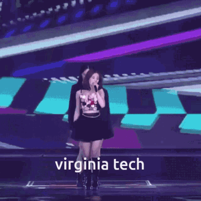 a girl singing into a microphone with the words virginia tech written below her
