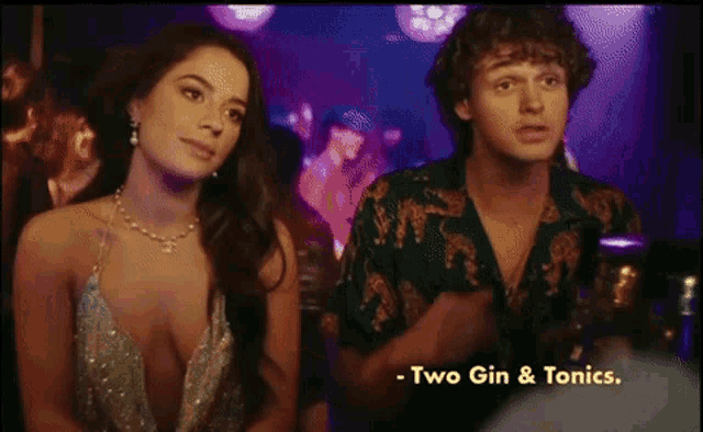 a man and a woman are standing next to each other in a club with the words two gin & tonics written below them