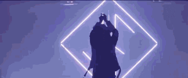 a man singing into a microphone on a stage
