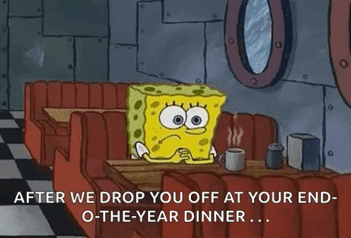 spongebob squarepants is sitting at a table in a diner .