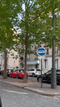 a blue sign on the side of a street says no parking except buses