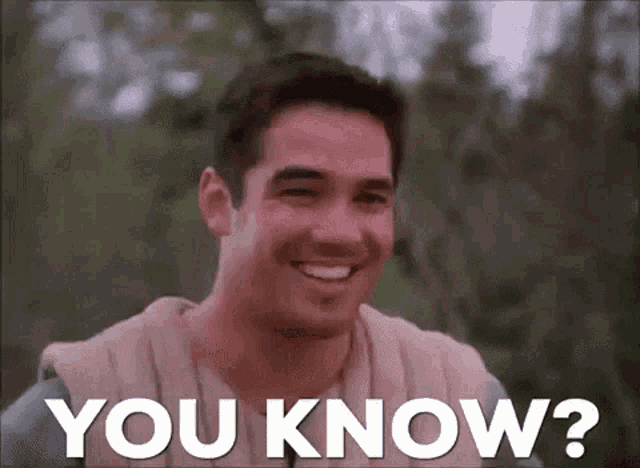 a man is smiling with the words `` you know '' written next to him .