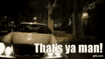 a car is driving down a street at night with the words that 's ya man