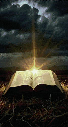 an open bible with the sun shining through the clouds in the background