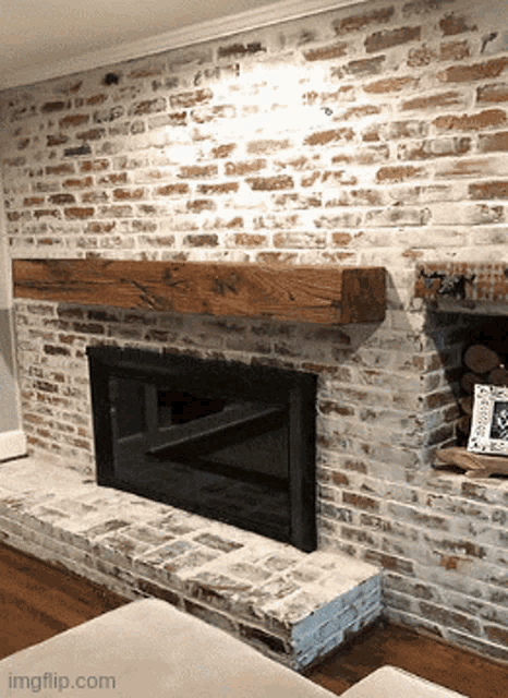 a brick fireplace with a wooden mantle and a picture on the mantle that says welcome