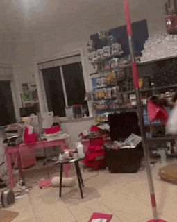 a very messy room with a mop in the middle of it