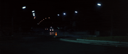 a white van is parked on the side of a road at night