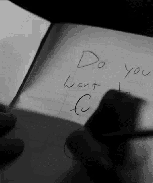 a black and white photo of a person writing " do you want c "