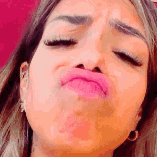 a close up of a woman 's face with a pink lip