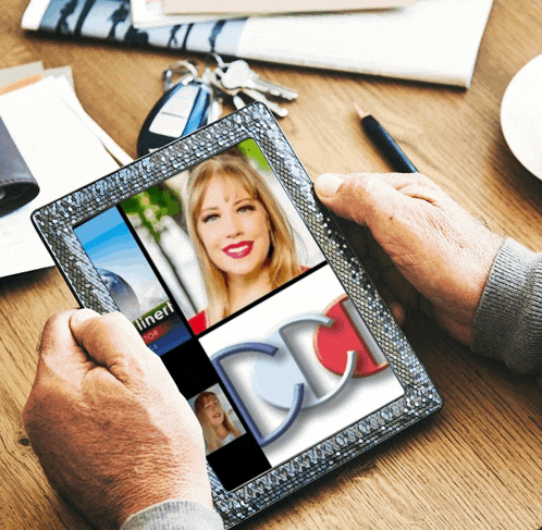 a person is holding a tablet with a picture of a woman and the letters cd on it