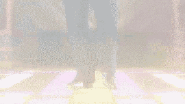 a man in a suit is dancing in a club