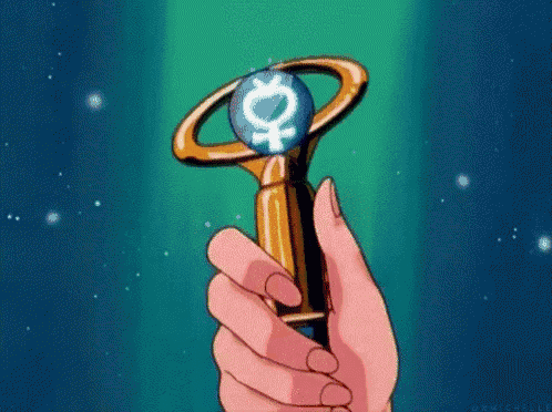 a person is holding a wand with a female symbol on it in their hand .