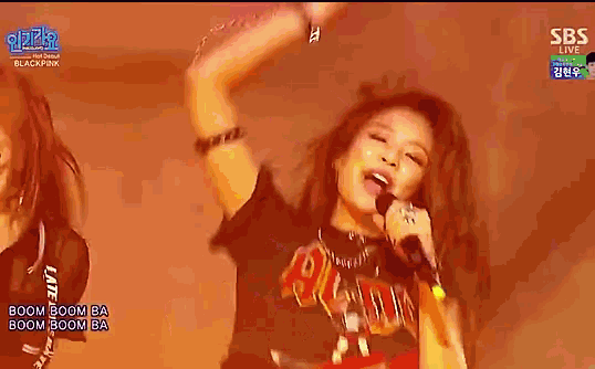 a woman is singing into a microphone while wearing a shirt that says acdc