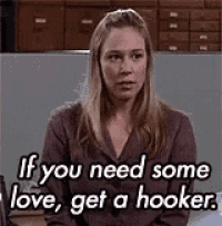a woman is sitting in a room with a quote that says `` if you need some love , get a hooker '' .