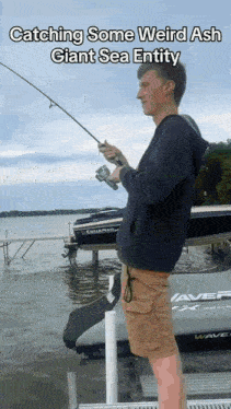 a man holding a fishing rod in front of a boat with the words catching some weird ash giant sea entity