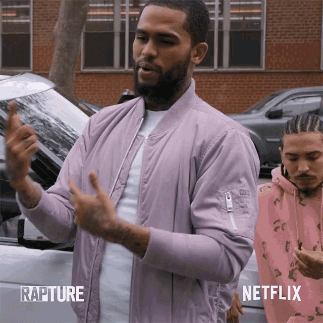 a man in a pink jacket is standing next to another man in a pink hoodie with rapture written on the bottom