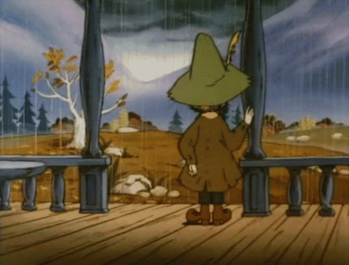 a cartoon character in a green hat is standing on a balcony