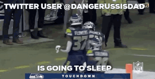 two football players are hugging each other on a field .