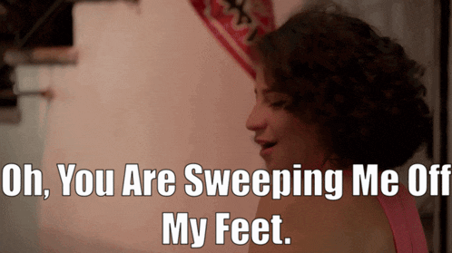 a woman in a pink tank top says oh you are sweeping me off my feet