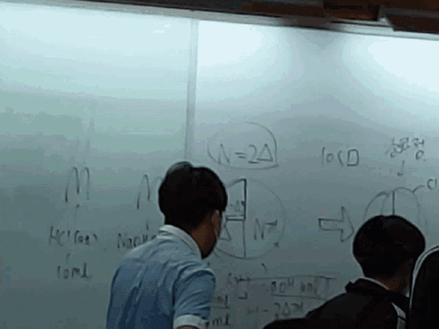 a man stands in front of a whiteboard with a drawing of n = 24