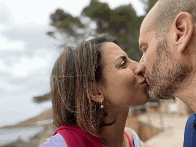 a man and a woman are kissing each other