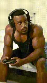 a man is wearing headphones and holding a video game controller