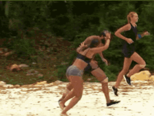 a group of women are running on a beach