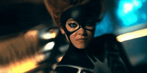 a woman in a superhero costume with a mask on her face