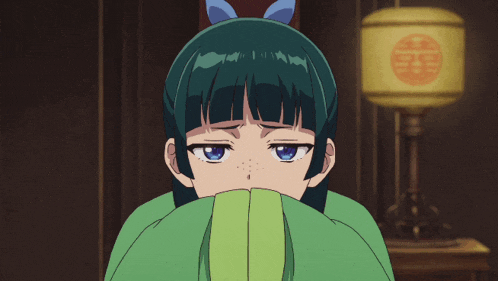 a girl with green hair and blue eyes covering her face with her hand