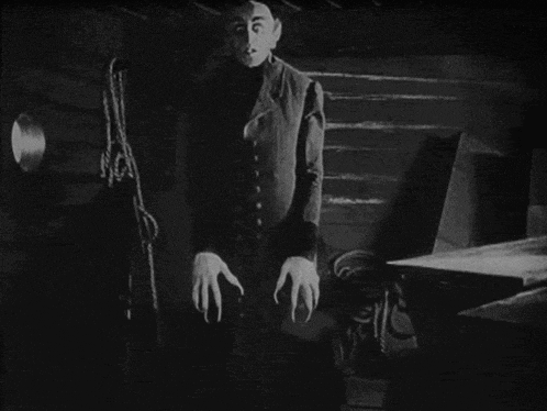 a black and white photo of a man with claws