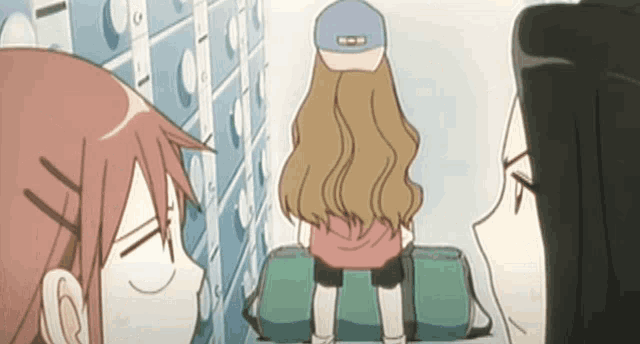 a girl in a baseball cap is standing in a hallway with other girls