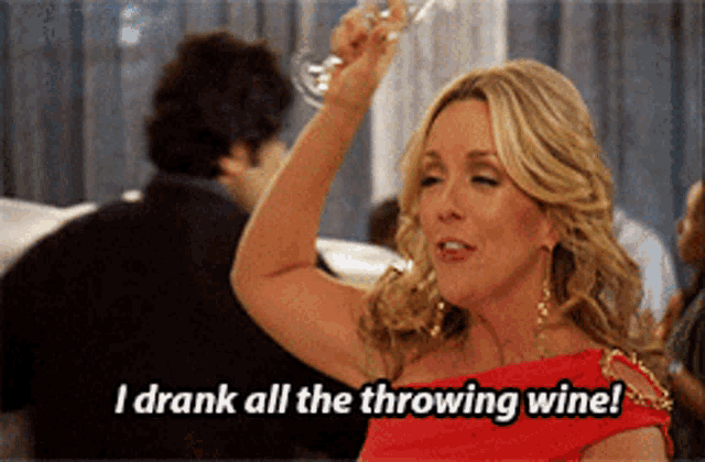 a woman in a red dress holds a glass of wine and says i drank all the throwing wine