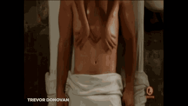 a man is getting a massage from a woman in a towel .