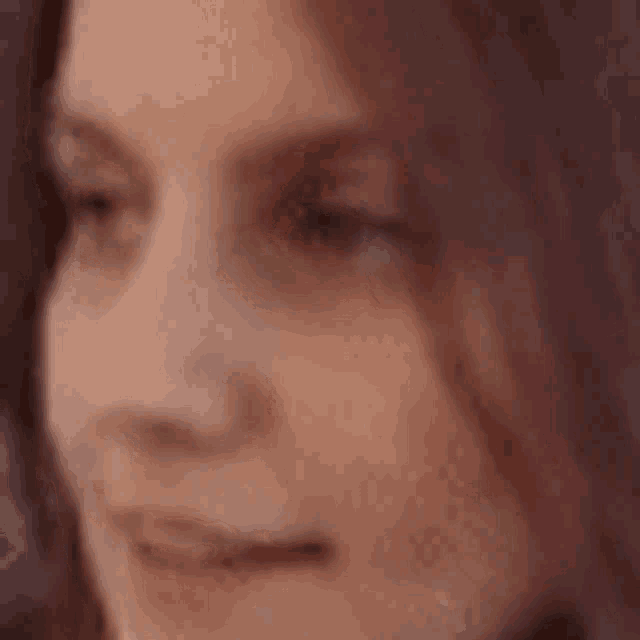 a close up of a woman 's face with long hair .