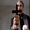a priest is holding a cross in his hand .