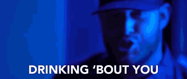 a man wearing a hat is surrounded by blue light and the words drinking bout you