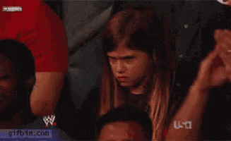 a girl sitting in a wrestling ring with a gifbin.com watermark