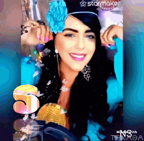 a woman wearing a blue flower in her hair is smiling in a starmaker video