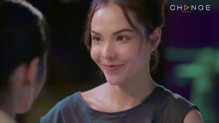 a close up of a woman 's face with a pixelated background .