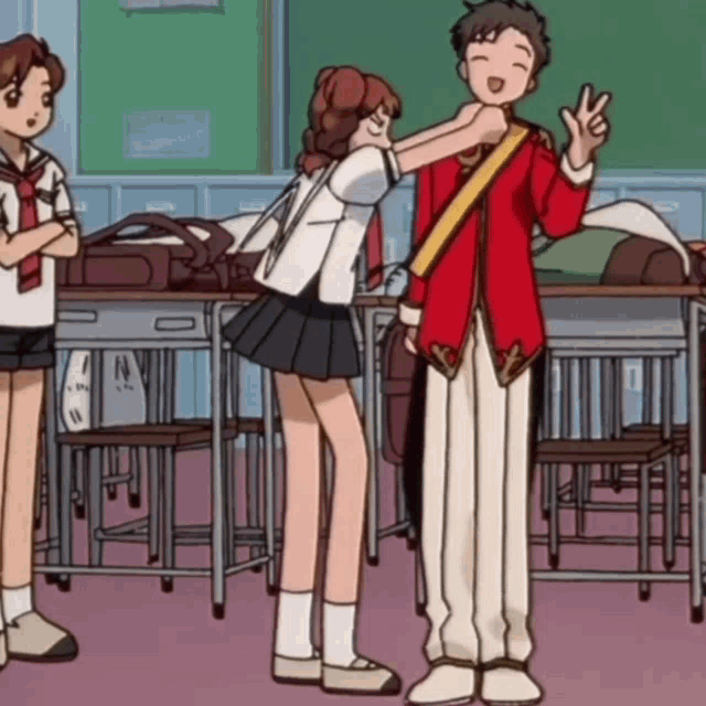 a boy in a red jacket is giving a peace sign