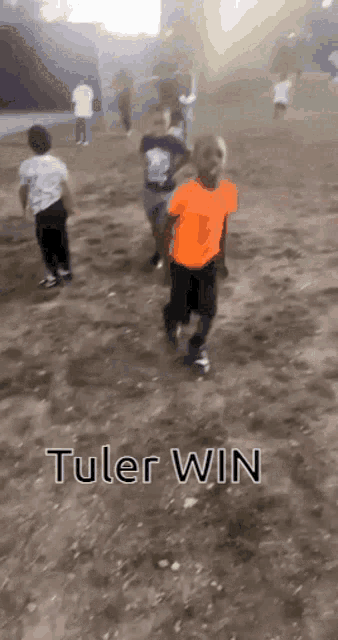 a group of children are running in a dirt field with the words tuler win written on the bottom