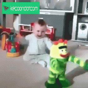 a baby is playing with a stuffed animal in front of a green sign that says kpc condo.com