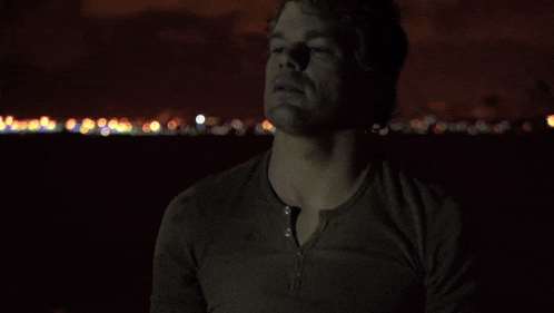 a man in a dark room with a blurry background