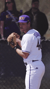 a baseball player wearing a purple hat that says ecu on it