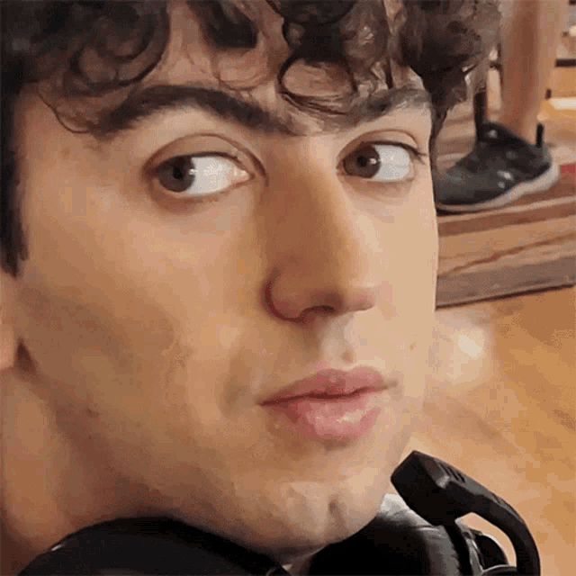 a close up of a man 's face with his eyes closed and his mouth open